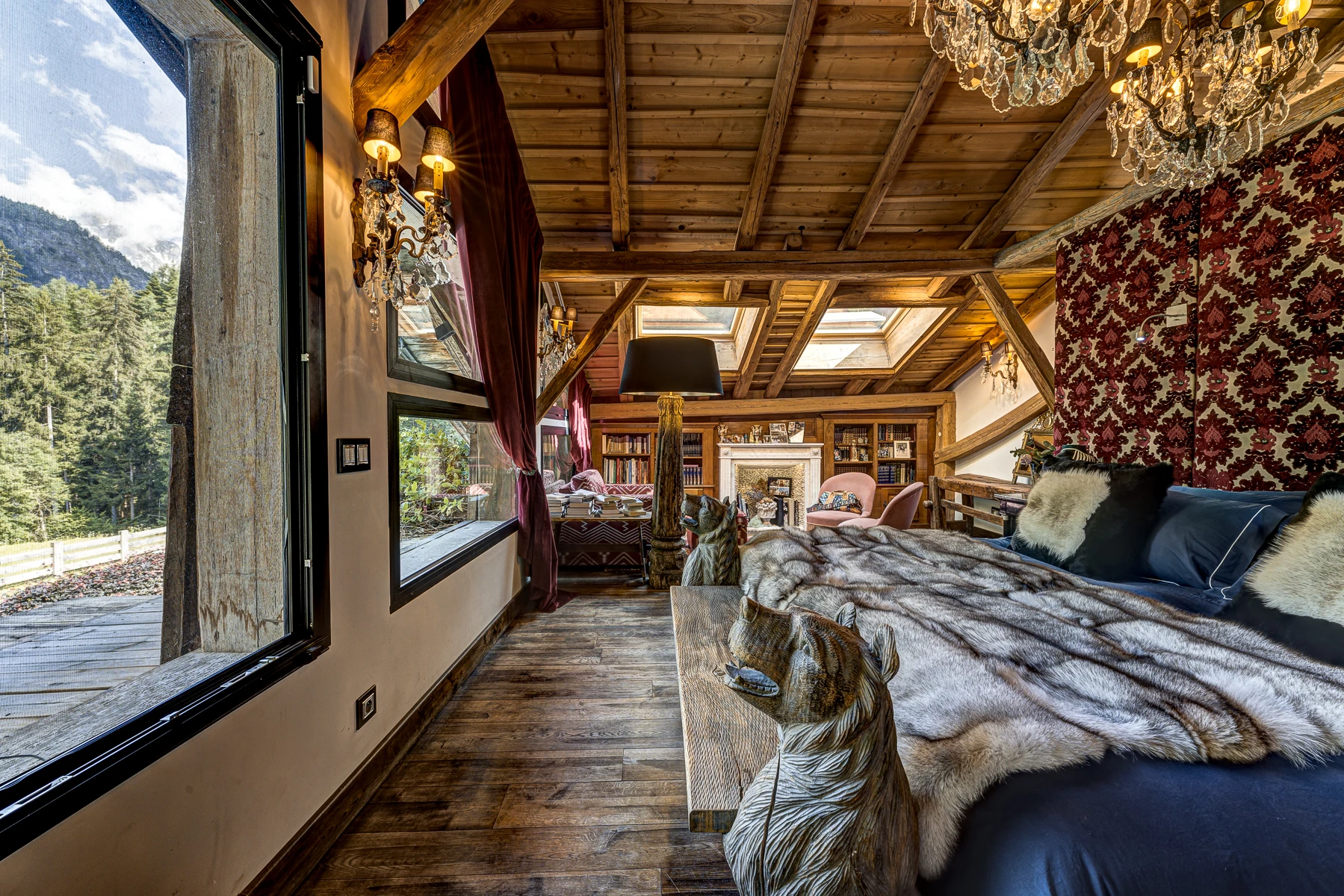 Photo du lit king size de la chambre master avec la grande fenêtre qui donne sur le jardin