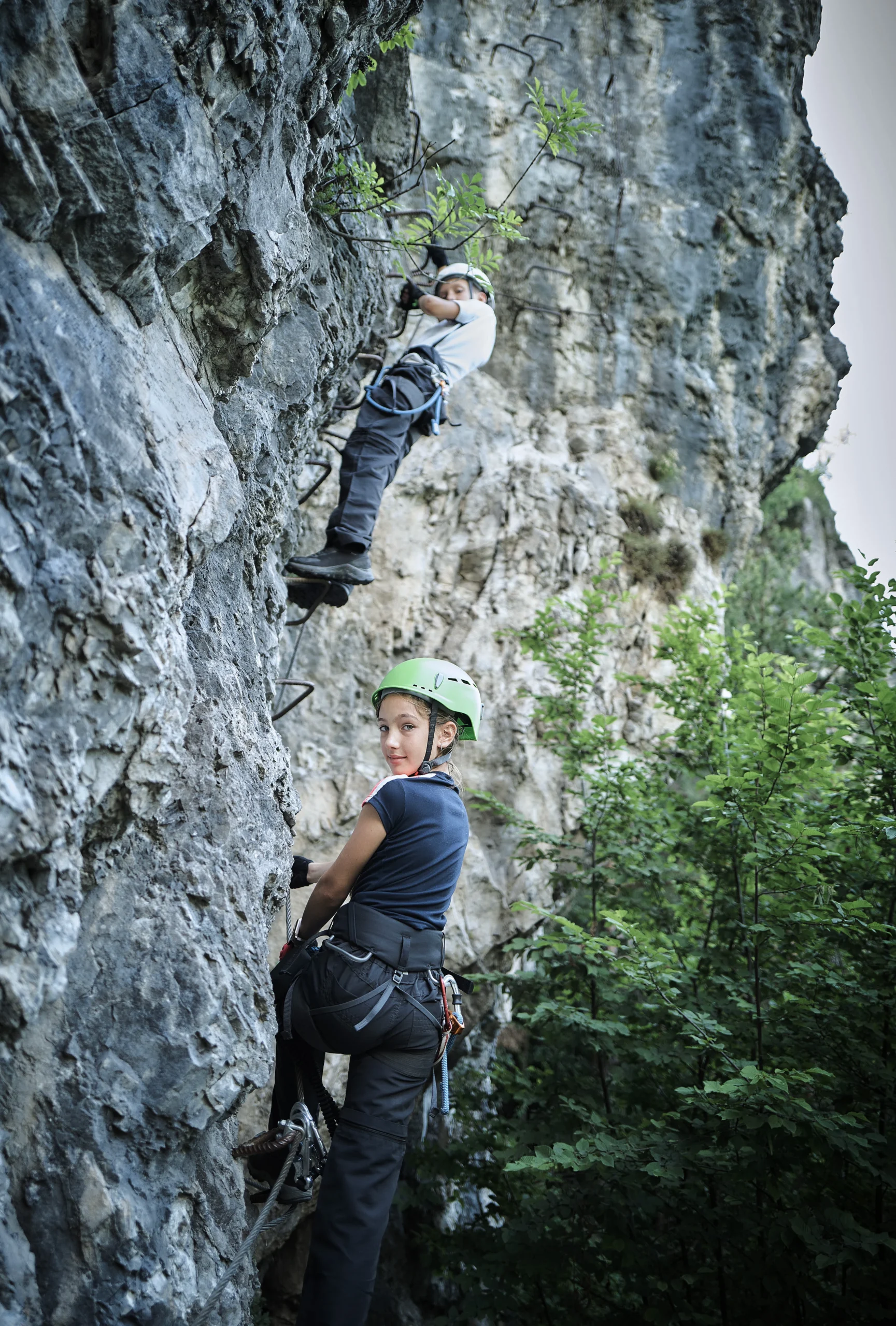 Photo d'un garçon et un fille qui font de la via ferrata